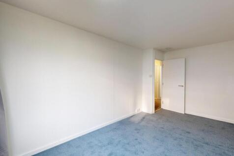 Bright and spacious living room with neutral wa...