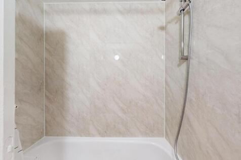 A modern bathroom with a large, clean shower ar...