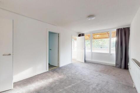 Bright and spacious living room with large wind...
