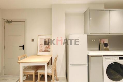 Modern and bright kitchen featuring ample cabin...