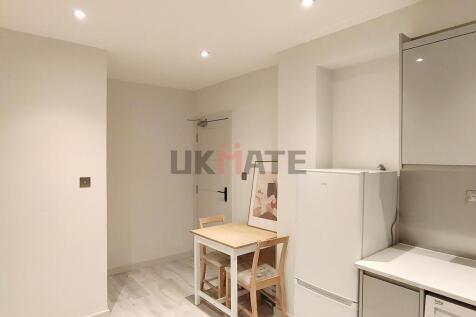 A bright, modern kitchen with ample lighting an...