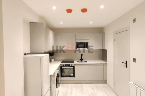 Modern, minimalist kitchen with sleek grey cabi...