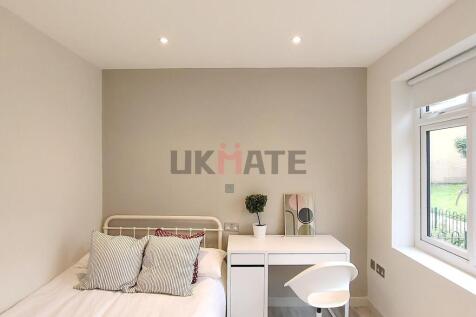 A bright and inviting single bedroom featuring ...