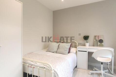Bright and clean bedroom featuring a white bed ...