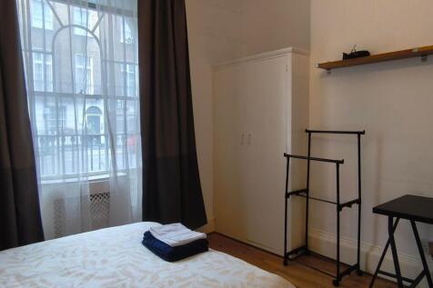 Bright and inviting bedroom featuring large win...