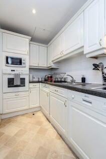 A bright and well-maintained kitchen with white...