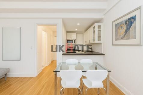 Bright and modern kitchen featuring white cabin...