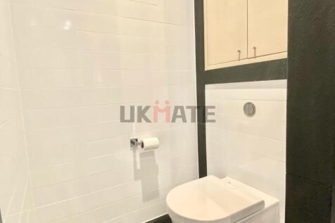 Modern bathroom featuring a toilet with a sleek...