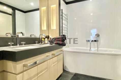 Modern bathroom featuring a double sink vanity,...