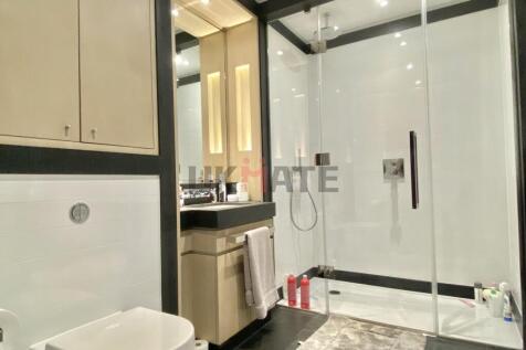 Modern bathroom featuring a spacious shower enc...