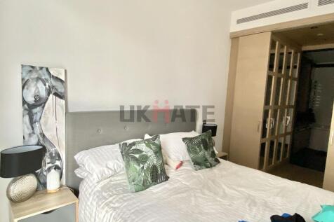 A spacious and inviting master bedroom featurin...