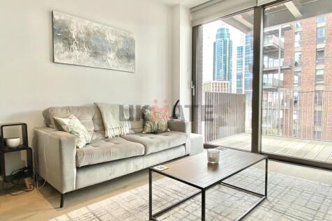Modern, well-lit living room with a comfortable...
