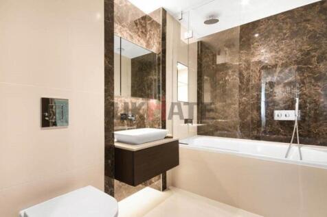 Modern bathroom featuring a sleek bathtub, a st...