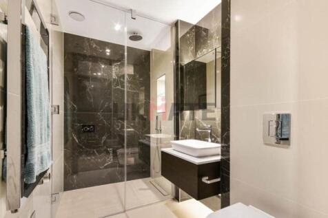 Modern bathroom with sleek black marble walls, ...
