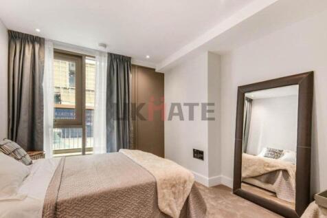 A cozy and well-maintained bedroom with a comfo...