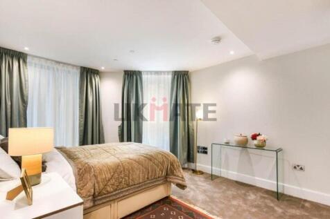 A spacious and well-lit bedroom with a comforta...
