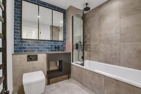 Modern, clean bathroom featuring a bathtub, wal...
