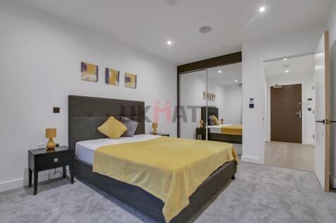 A modern and spacious master bedroom featuring ...