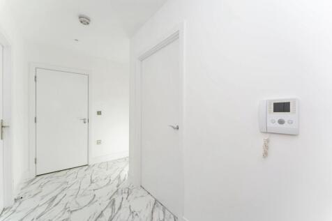 Bright and clean hallway featuring modern white...