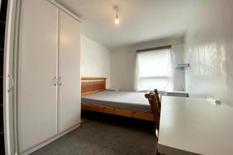 A spacious and well-lit double bedroom featurin...
