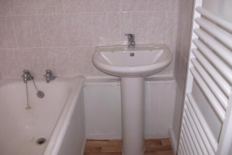 A tidy bathroom featuring a bath and sink, perf...
