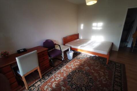 A spacious and well-lit double bedroom featurin...