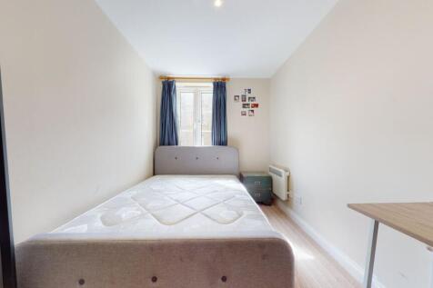 Bright and simple bedroom featuring a comfortab...