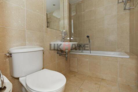 Modern bathroom featuring a large bathtub, a co...