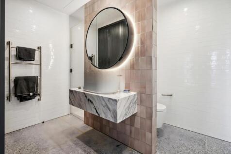 Modern bathroom featuring a sleek marble vanity...