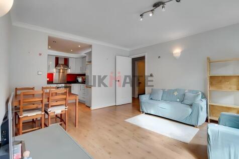 Bright and spacious living room featuring large...