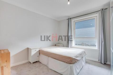 A bright and airy double bedroom featuring a la...
