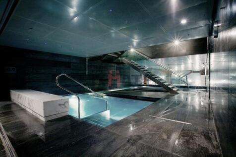 A sleek, modern spa-like bathroom with a luxuri...