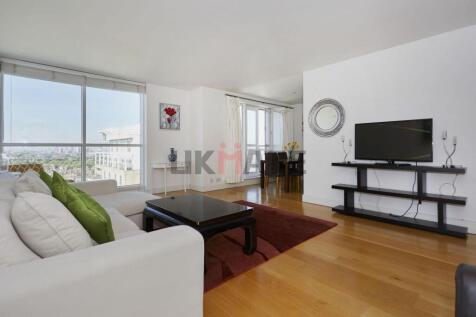 Bright and spacious living room with large wind...