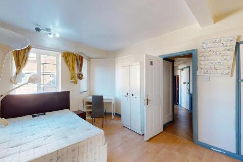 A bright and cozy bedroom with two windows prov...