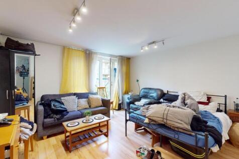 A spacious living room filled with natural ligh...
