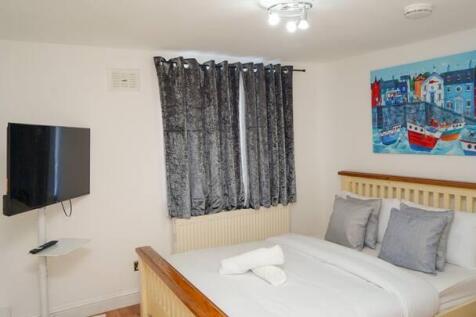 A cozy double bedroom featuring a comfortable w...