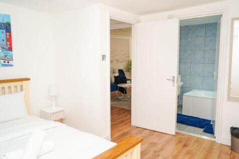 Bright and clean double bedroom featuring crisp...