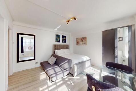 Bright and spacious living room featuring a com...