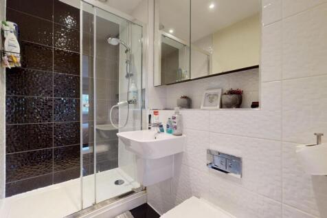 Modern bathroom featuring a sleek shower enclos...