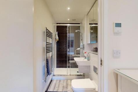 Bright and modern bathroom featuring a walk-in ...