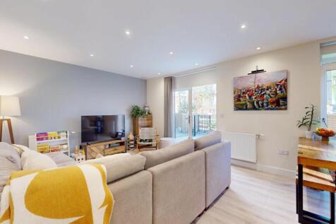 Bright and spacious living room with large wind...