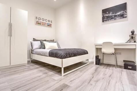 A modern and tidy double bedroom featuring a co...