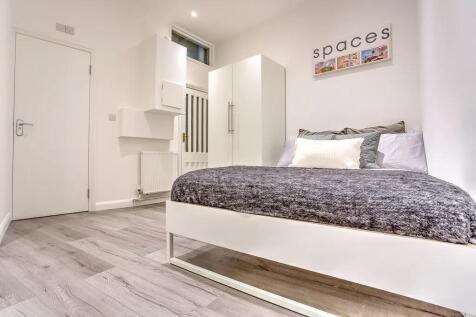 A bright and modern double bedroom featuring a ...