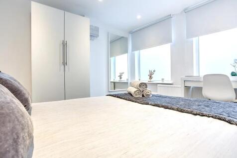 Bright and modern double bedroom featuring a la...