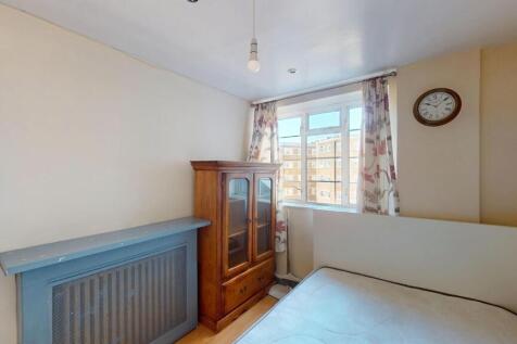 A cozy bedroom featuring a single bed, an antiq...