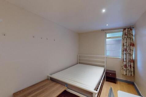 A bright and simple double bedroom featuring a ...
