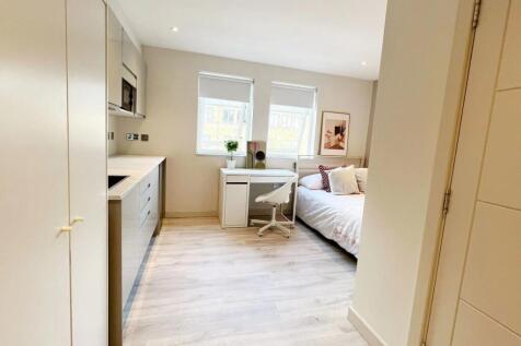 Bright and modern living room with large window...