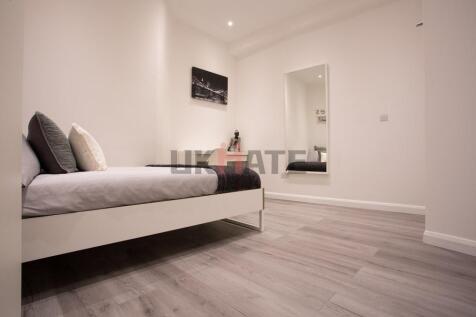 A modern, well-maintained bedroom featuring a c...