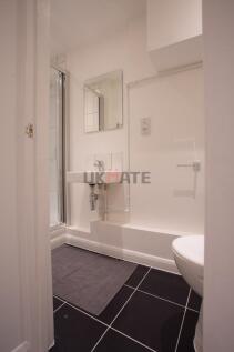 Modern and clean bathroom featuring a small sin...