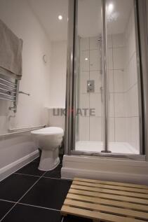 Modern and clean bathroom featuring a shower en...